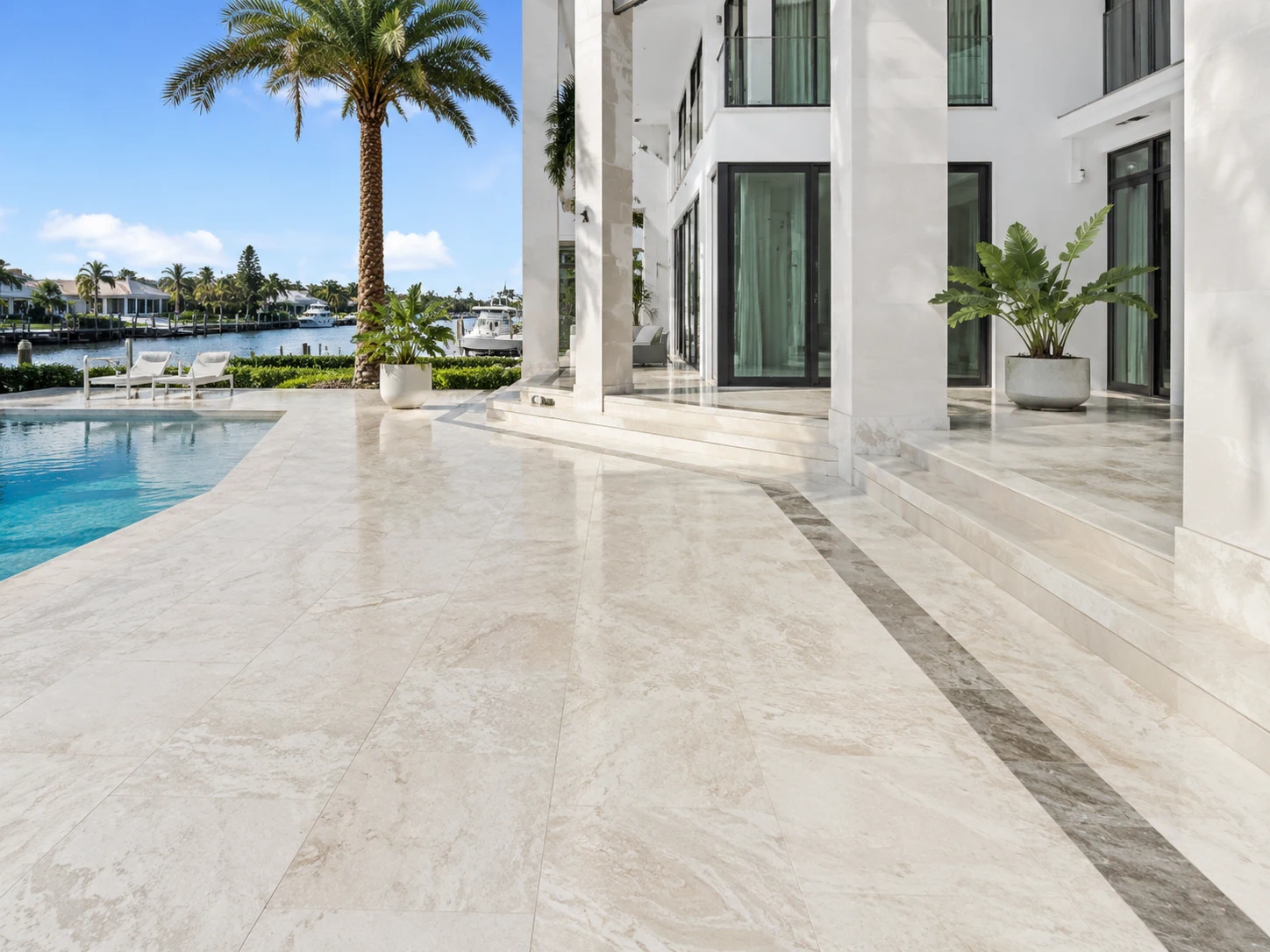 Light marble pool terrace with a bright refined natural stone finish